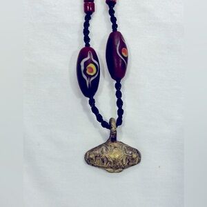 Funky red and black necklace with bronze pendant